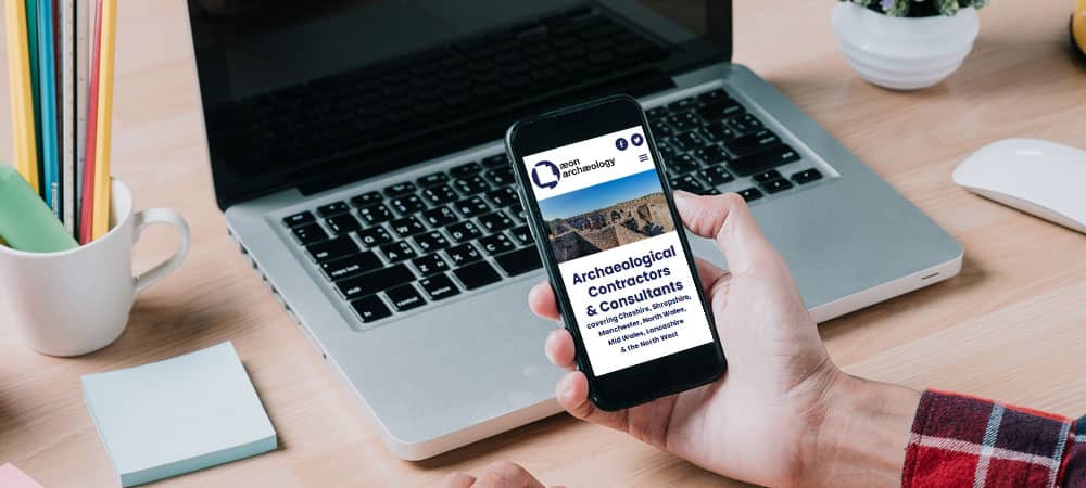 Person viewing the Aeon Archaeology website on mobile phone